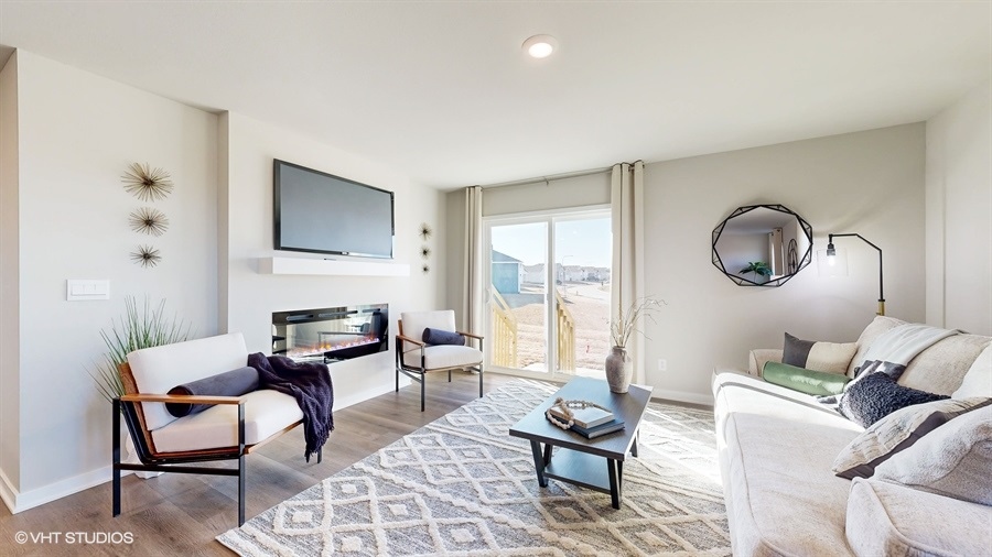 Overview of the Abbott bright and open living room with fireplace