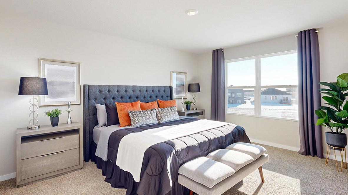 Primary bedroom with king bed and window