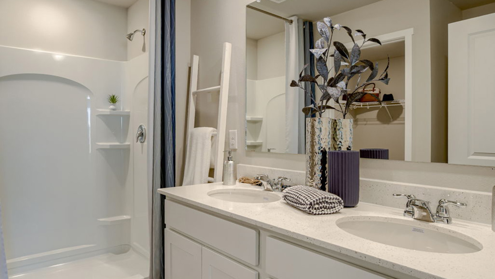 Primary bathroom in the Roland with dual sinks and walk-in shower