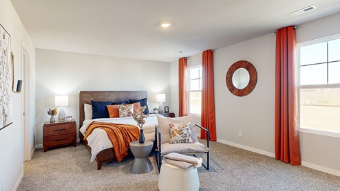 Big primary bedroom with two large windows