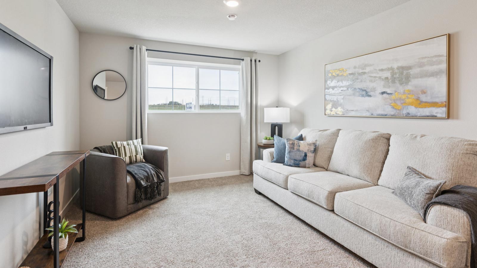 Second seating area with natural light and simple furnishings.