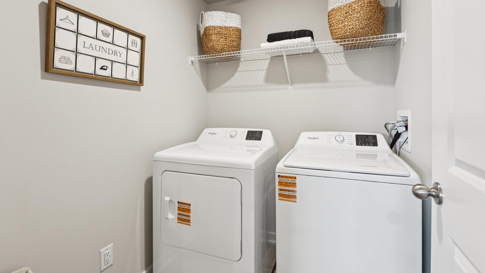 Laundry room with shelving above appliance hook ups.