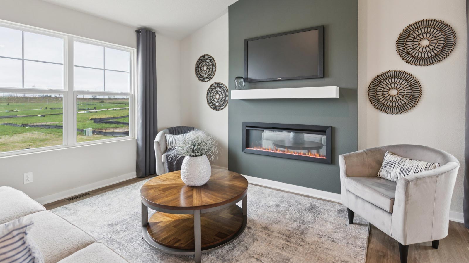 Open concept living space with natural light and simple furnishings.