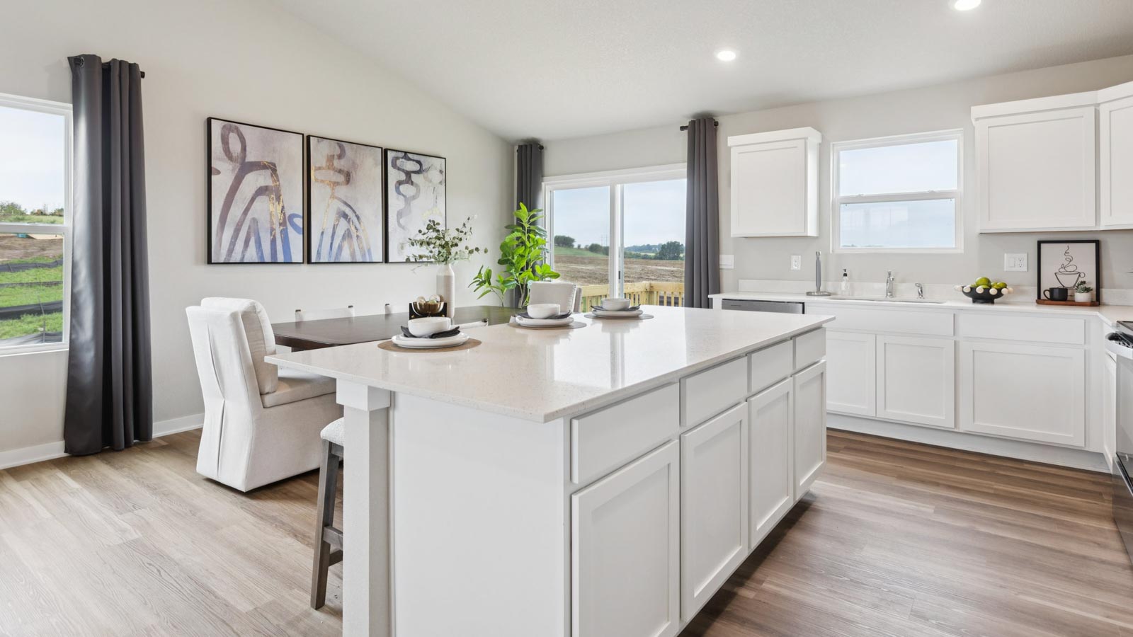Kitchen showcasing new stainless steel appliances, cabinets, and countertops.