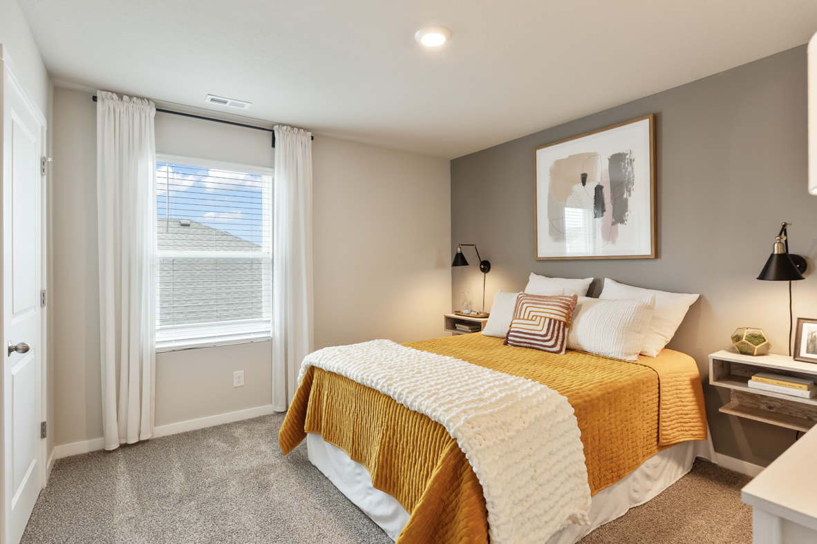 Secondary Bedroom with small window and overhead lighting