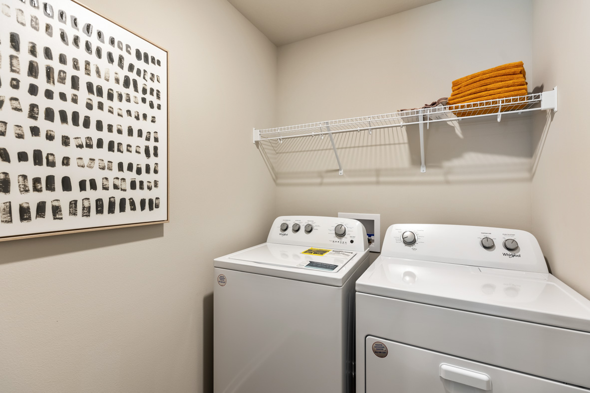 laundry room with washer and dryer and shelving