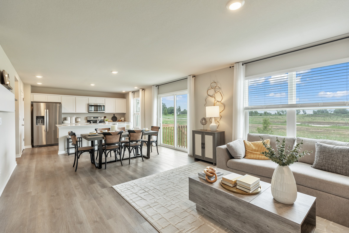 Living room with view of dining area and modern kitchen