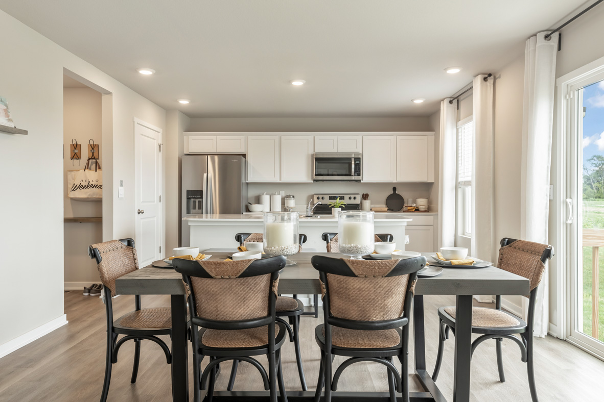 Dining room table with view of modern kitchen