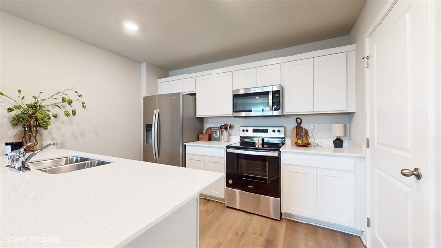 Kitchen with stainless-steel appliances and white cabinets