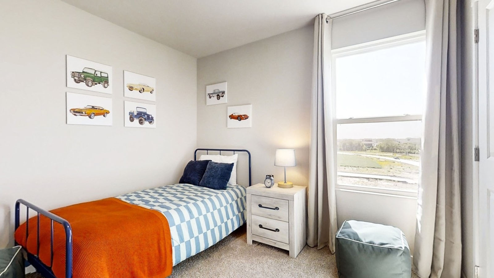 Second bedroom decorated for a child with a twin bed and car-themed décor