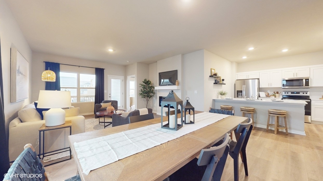 Wood dining table overlooking living room and kitchen