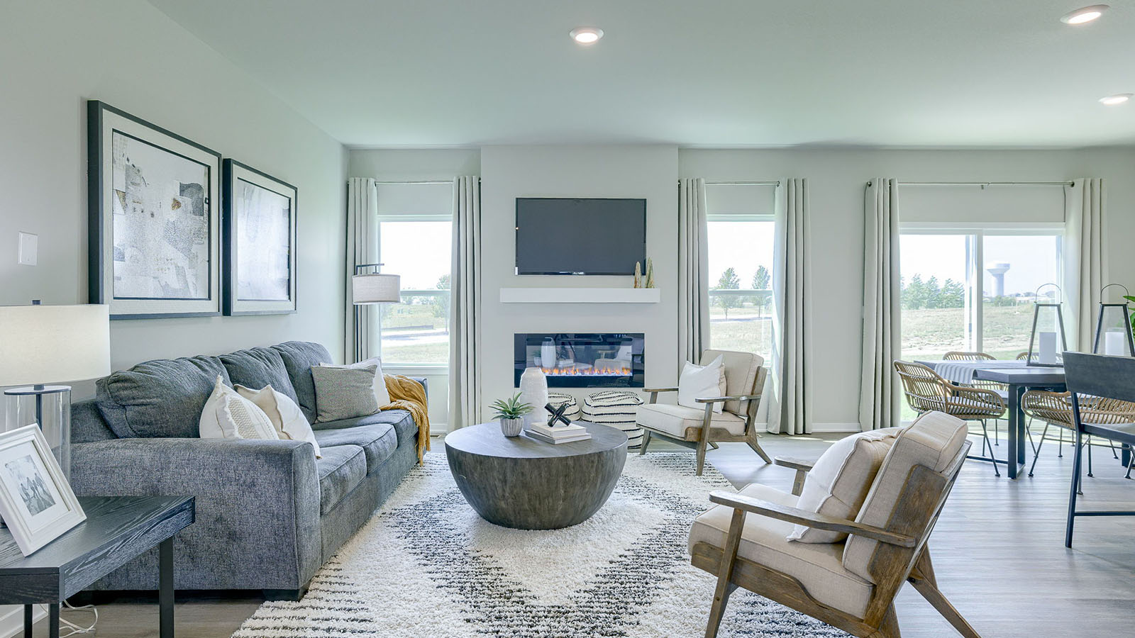 Reagan living room showcasing bright windows and grey couch
