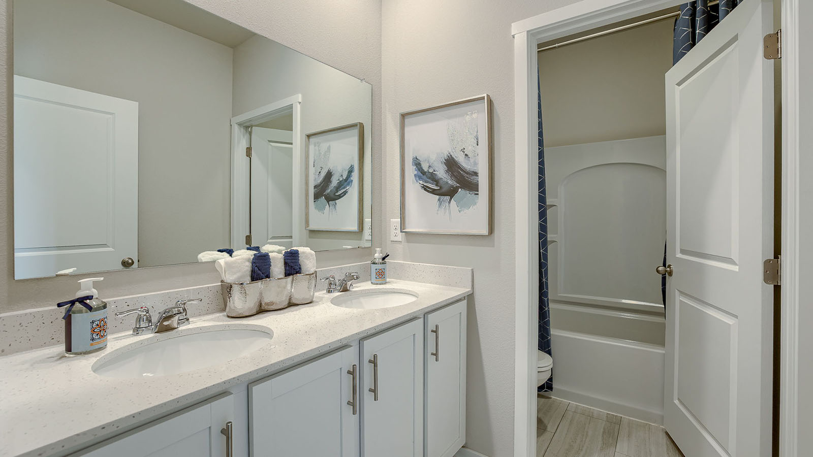 Secondary Bathroom with white lower cabinets