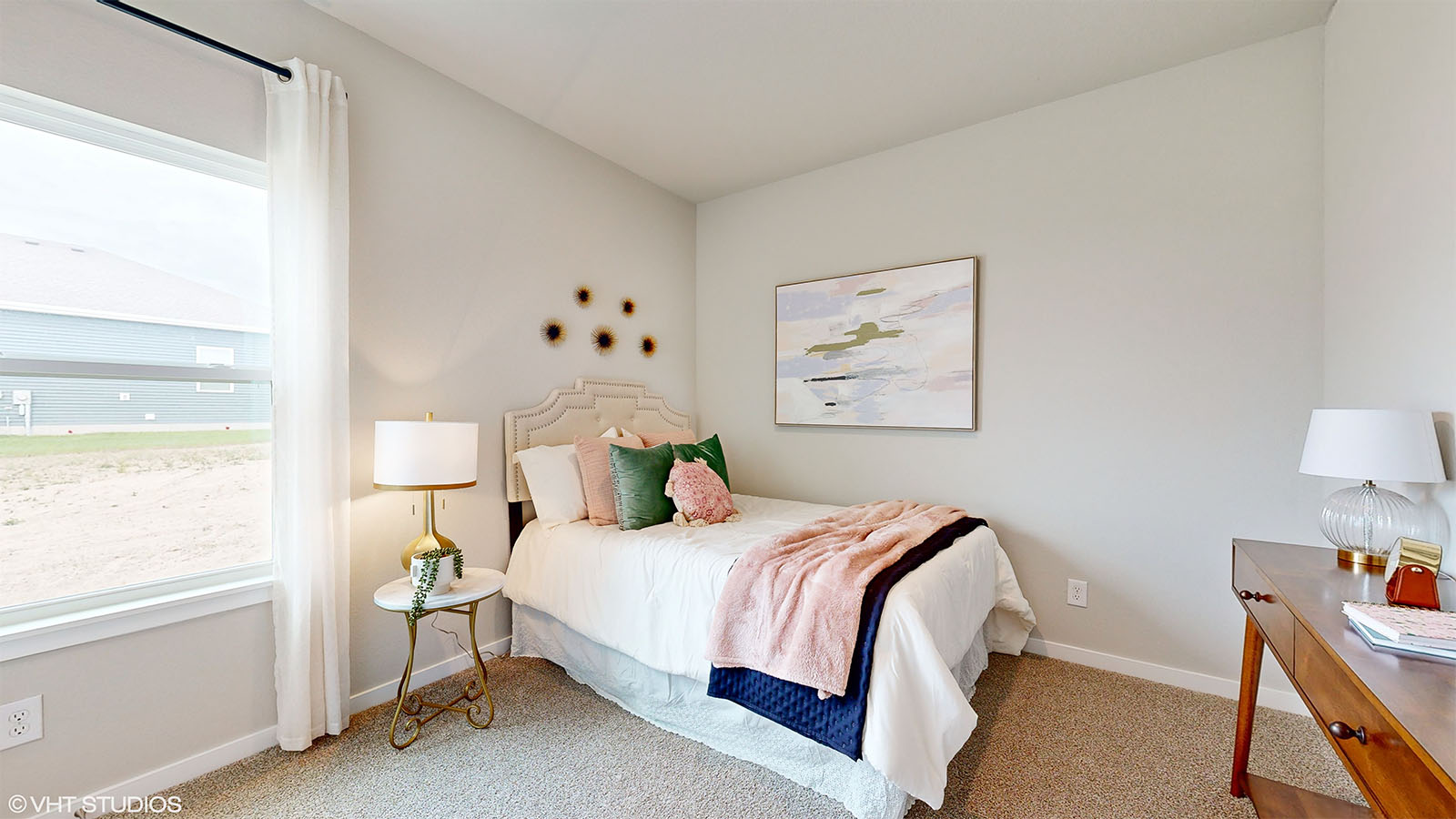 Third bedroom in the Fairfield staged for a pre teen with a twin bed night stand and desk