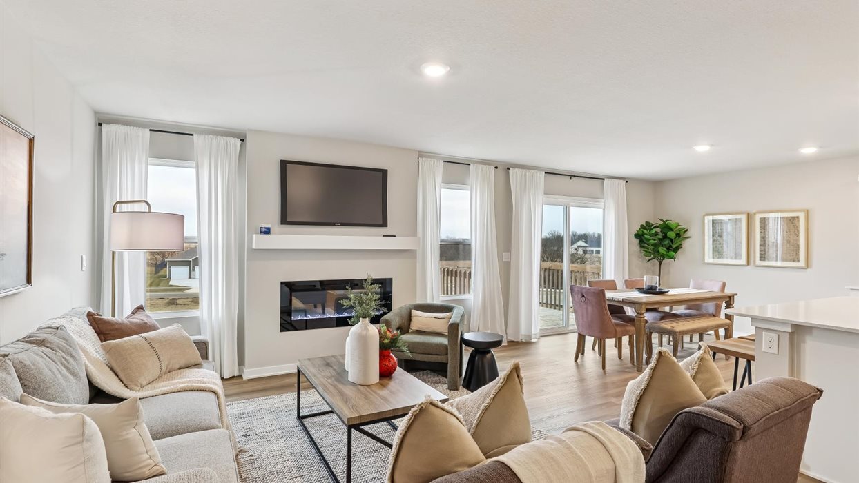 Living room of harmony with large windows and electric fireplace