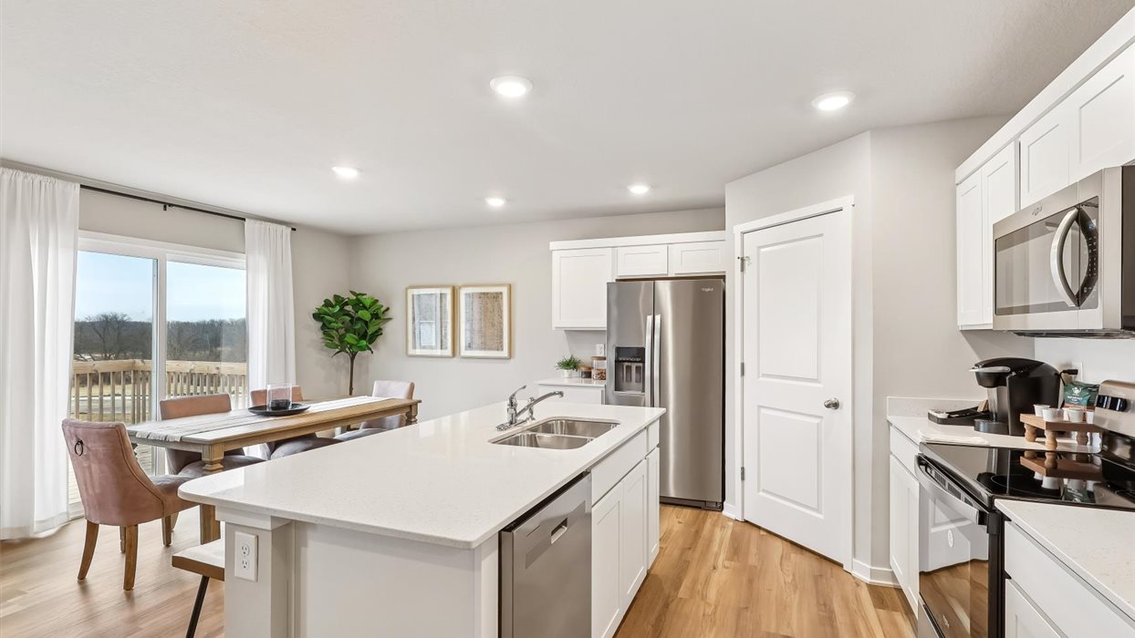 Kitchen of harmony with white cabnits and stainless steel applliances