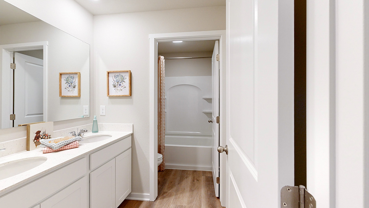 Second bathroom in the Reagan with dual sinks and separate toilet and shower room