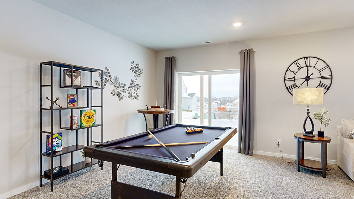 Reagan finished basement living room with a pool table and sliding glass door