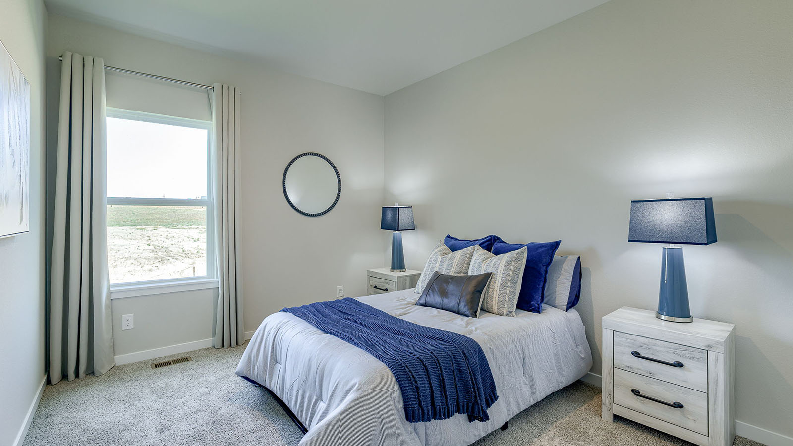 Third bedroom in the Reagan with a quen bed and white dresser