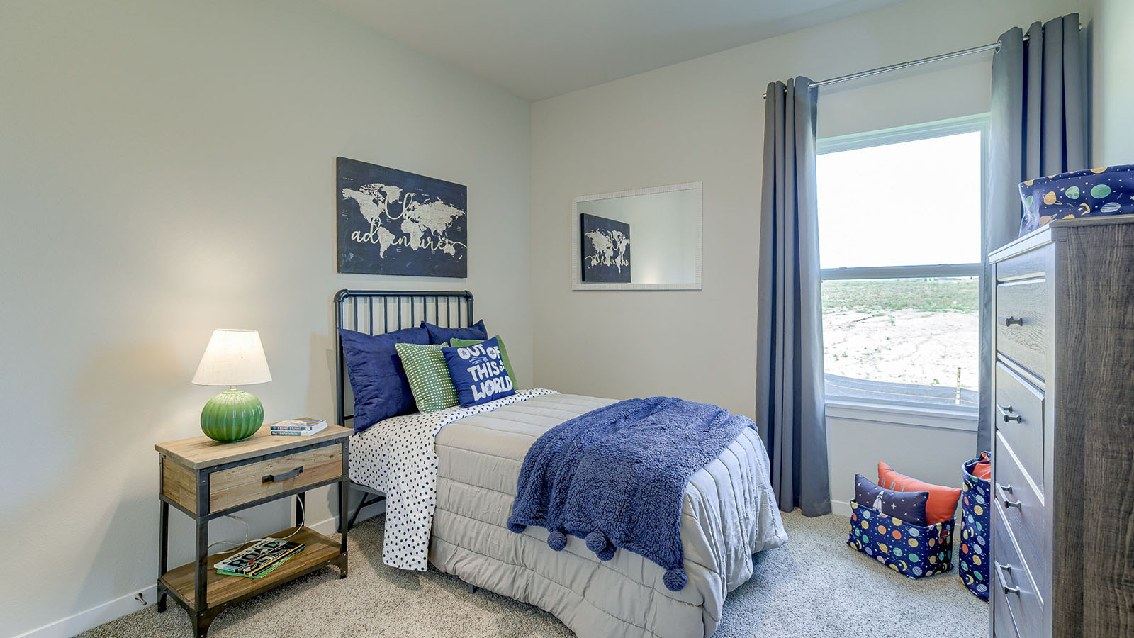 Second bedroom in the Reagan with twin bed and brown dresser