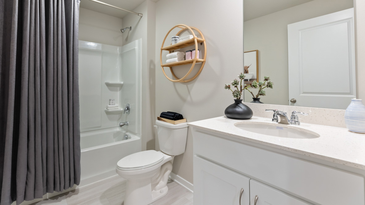 Third bathroom with white cabinets