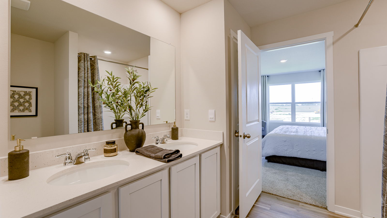 Primary bathroom in the Hamilton showing dual sinks and walk-in shower