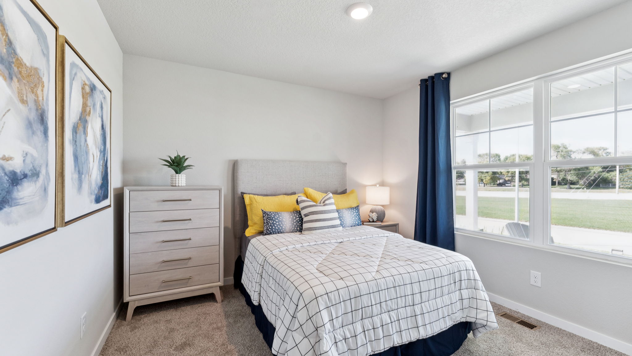 Second bedroom in the Hamilton with large window and full bed