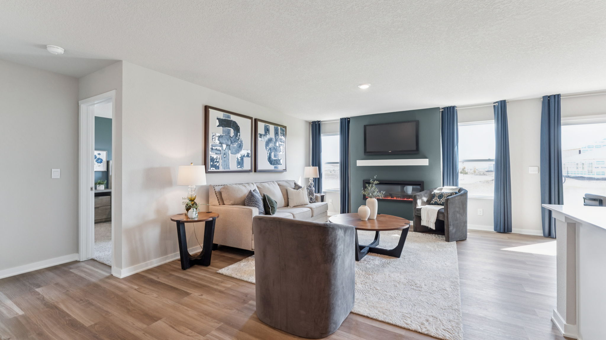 Overview of living room in the Hamilton with a couch and 2 chairs