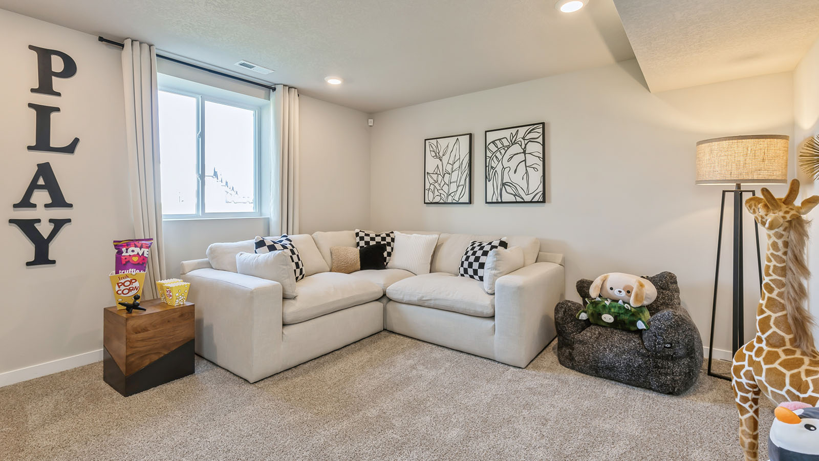 Finished basement with white couch and floor lamp
