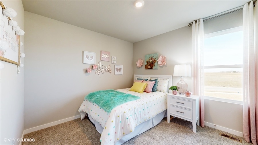 Third bedroom in the Abbott with a white full bed and window