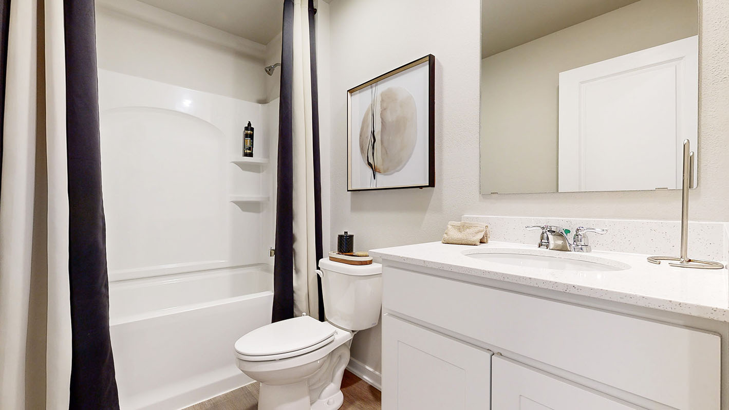 Second bathroom with a tub sink and toilet