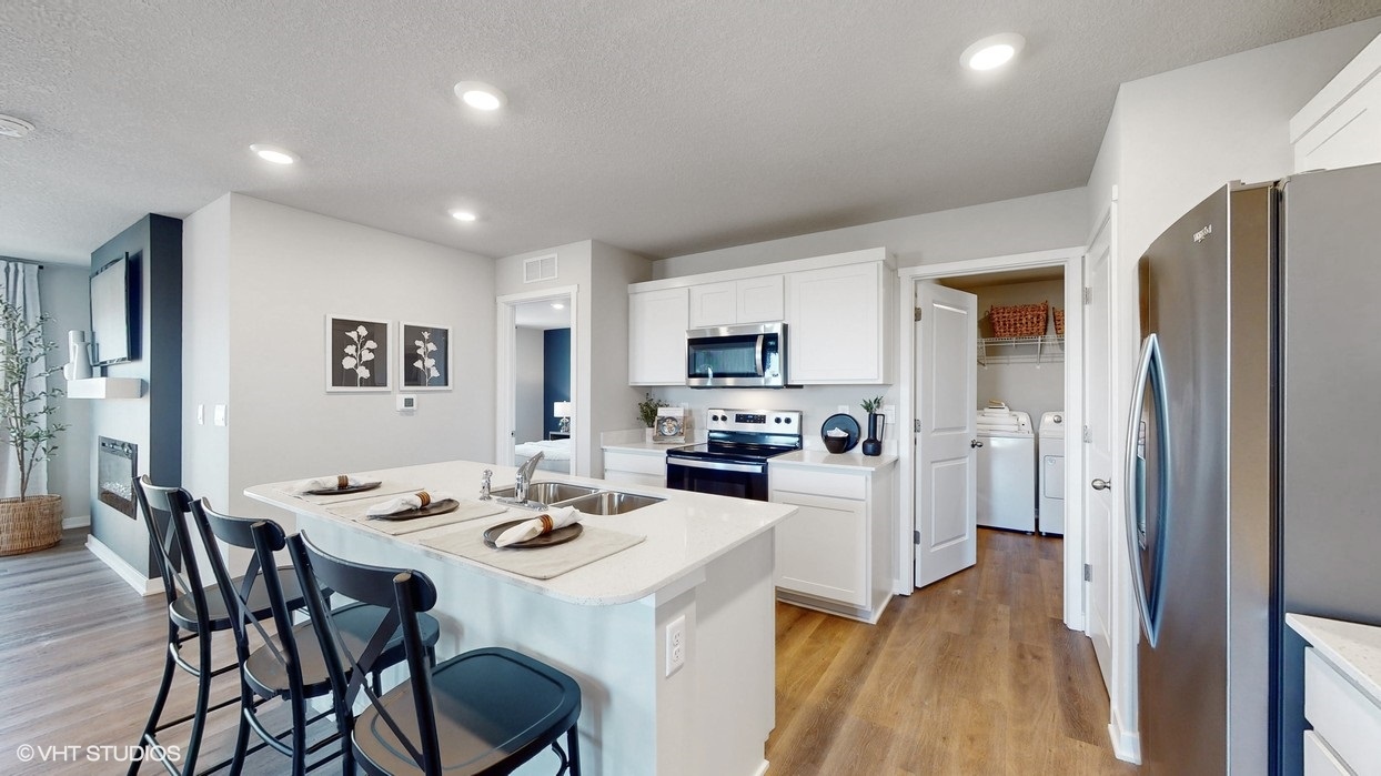 Open kitchen showing island and laundry room