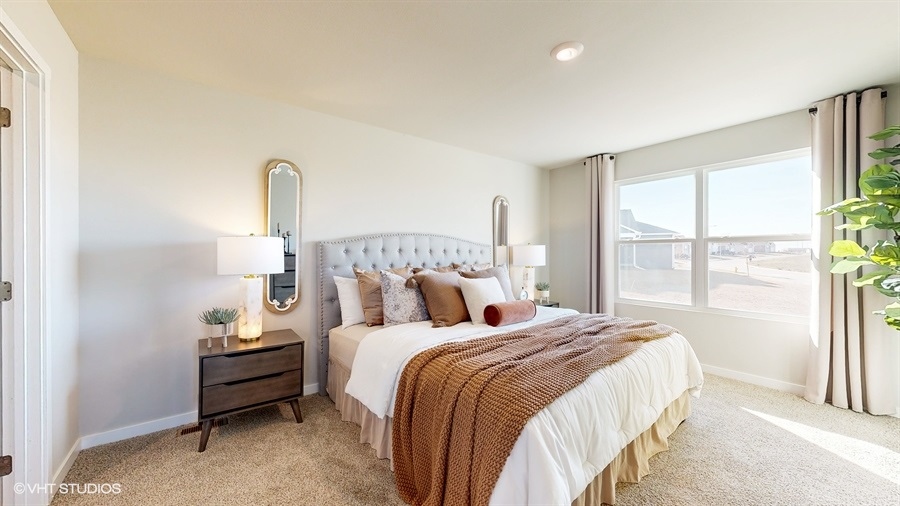 Bright primary bedroom in the Abbott with a king bed
