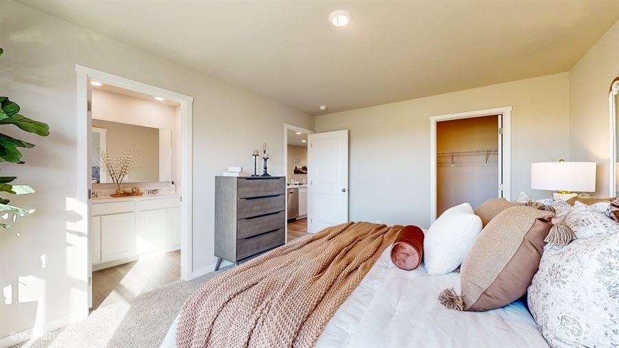 Primary bed showing primary bathroom and closet in the Abbott