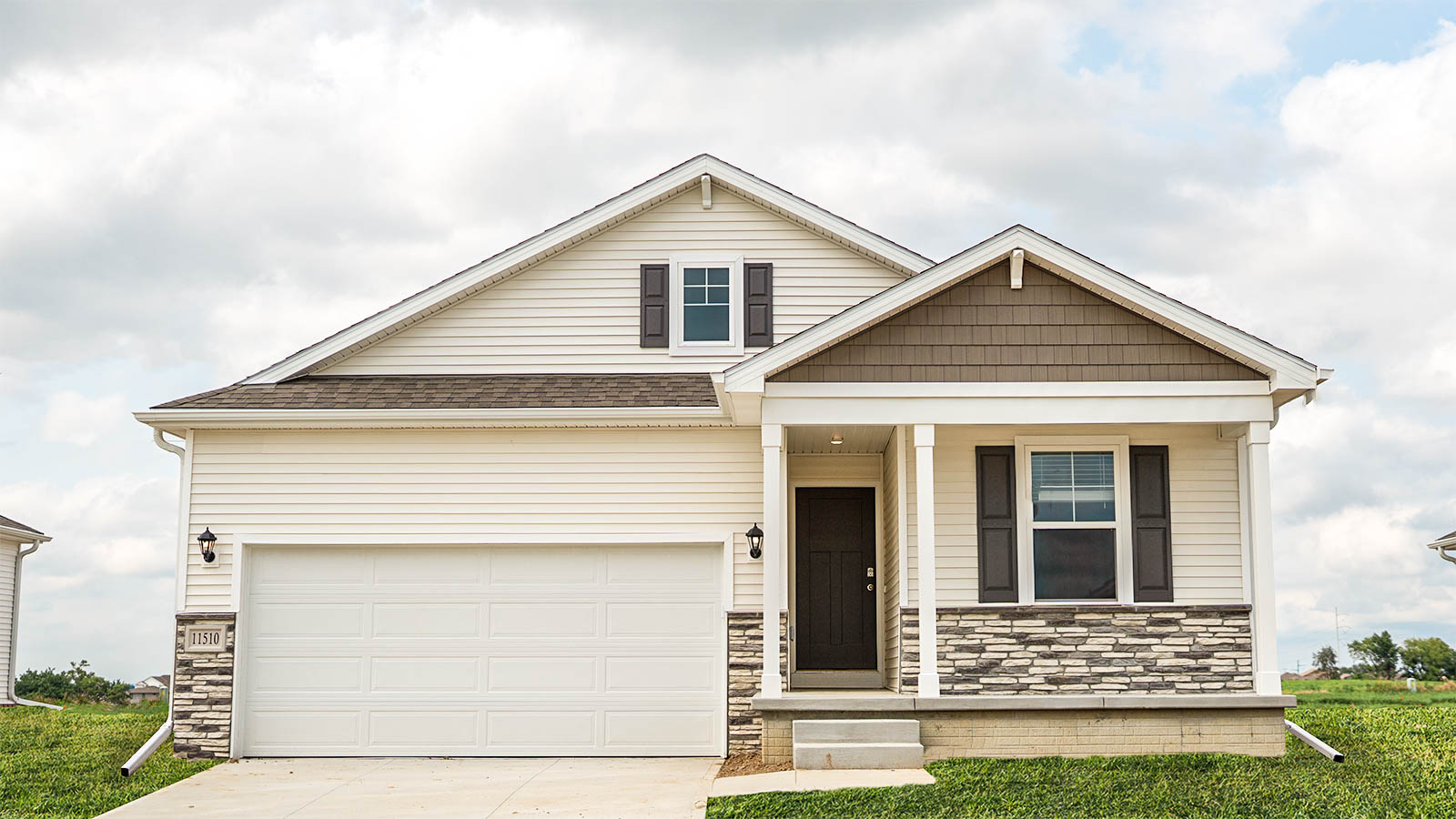 Exterior of Abbot, covered front porch, 2 car garage, with white siding