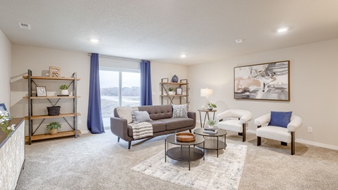 Finished basement of the Hamilton with a seating area and coffee table