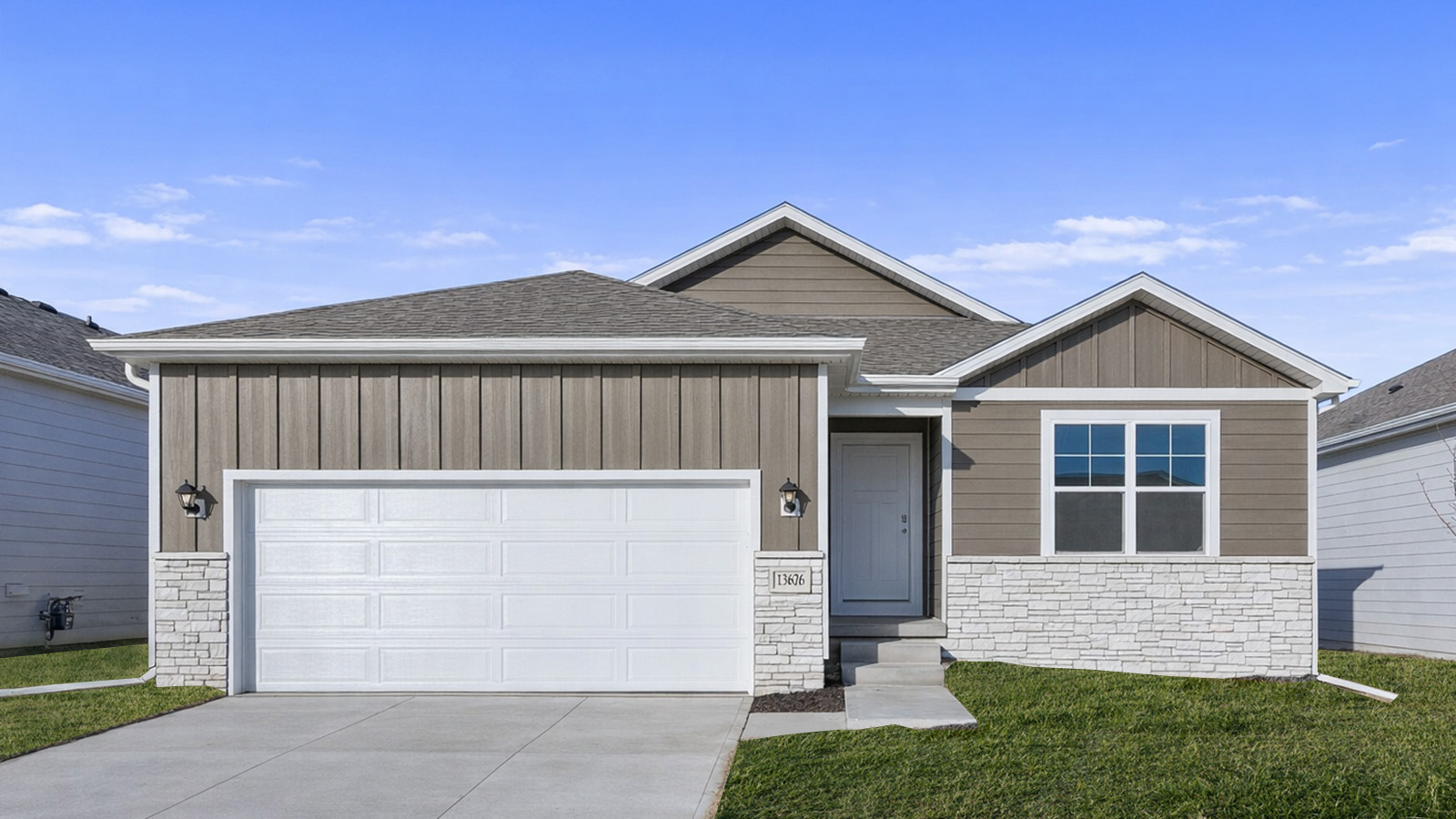 Exterior of Hamilton with no front porch, brown siding, and 2 car garage