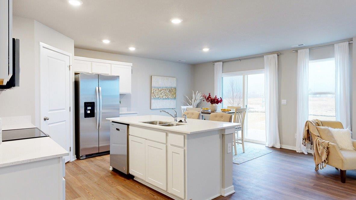 the Hamiltons kitchen showcasing the island and view into the dining room