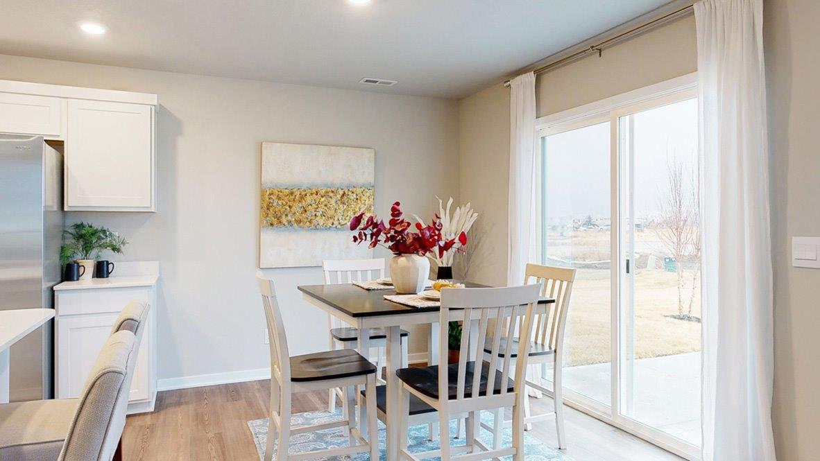 Hamilton dining room area with a table that seats 4 and a sliding glass door