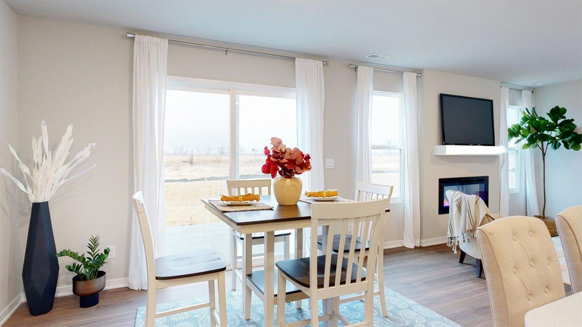 dining area of the hamilton with large sliding glass door to outdoor patio space