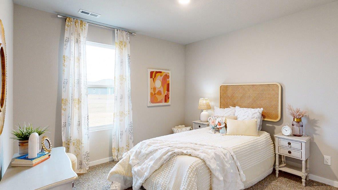 Third bedroom in the Hamilton with a twin bedstaged for a young girl