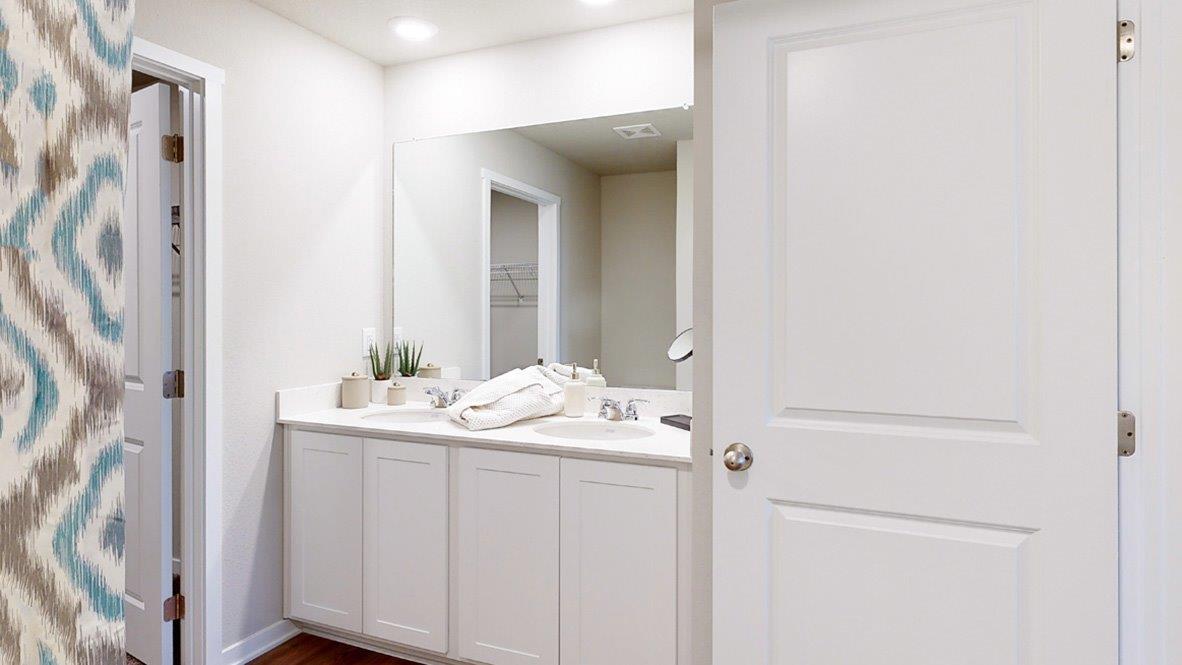 Master bathroom of the hamiton with a double sink vanity and large wall mirror