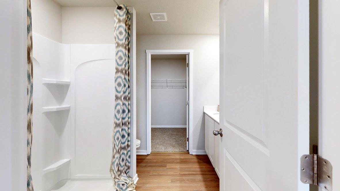 Primary bathroom in the Hamilton with walk in shower toilet dual sinks