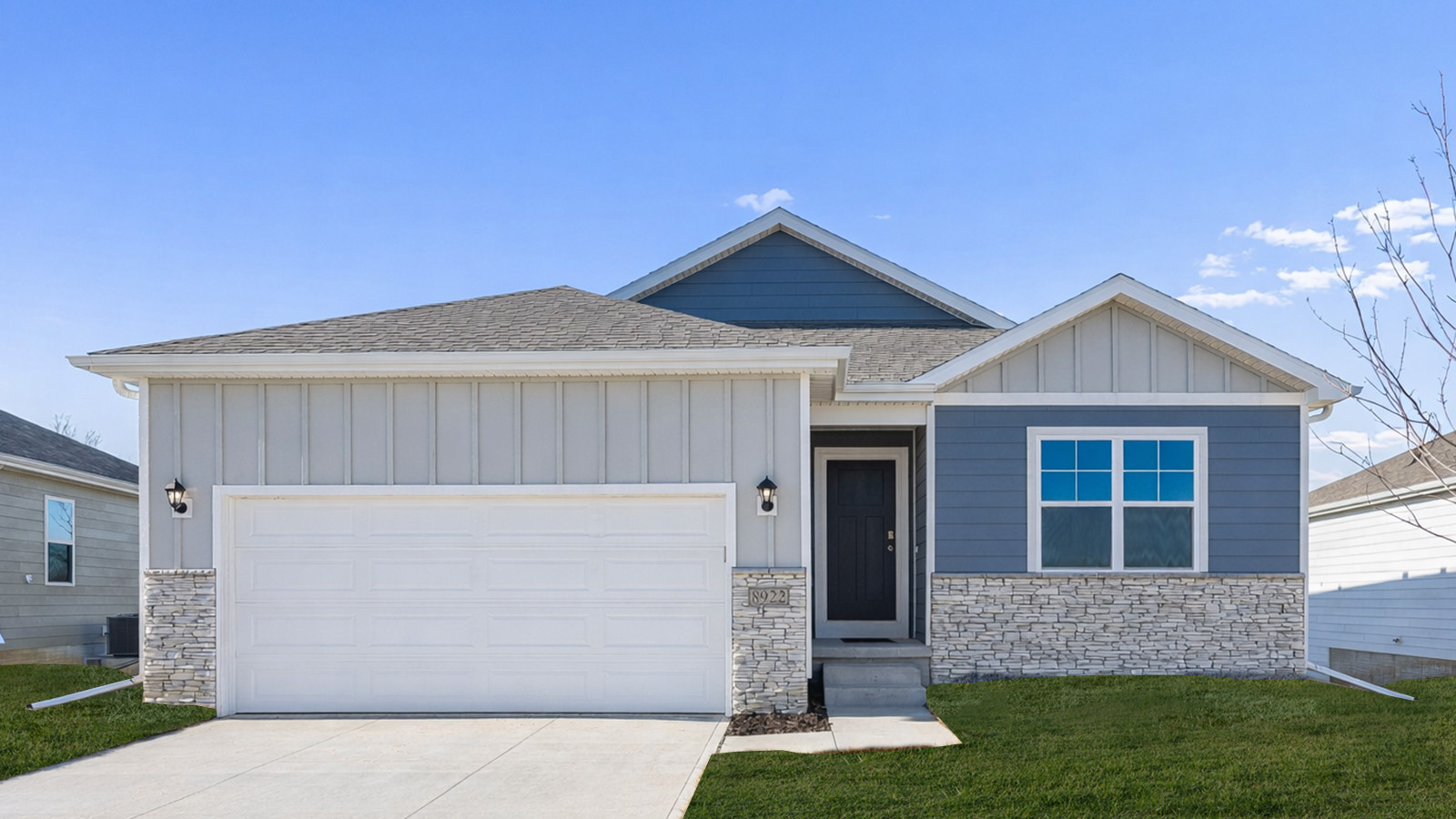 Exterior of Hamitlon floorplan with light blue siding, white brick, and a two car garage