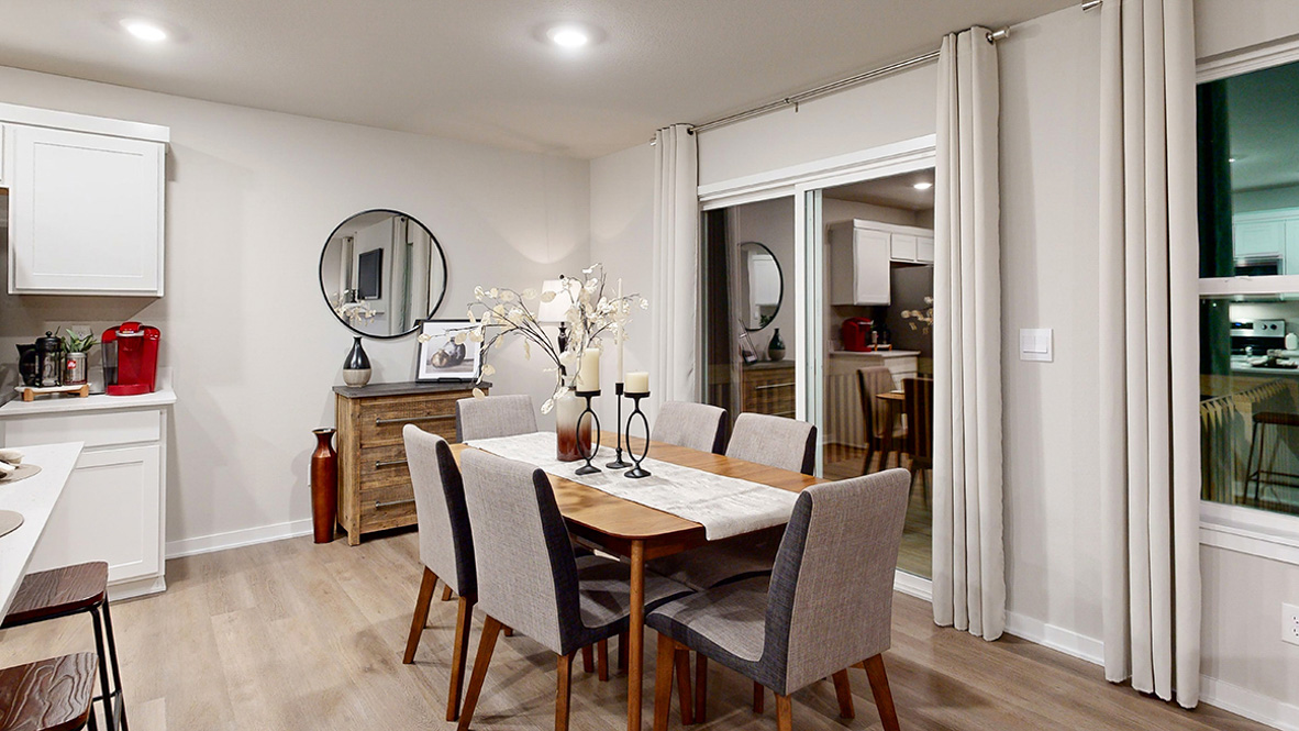 Dining room in the Hamilton with a long table that seats 6 and a sliding glass door