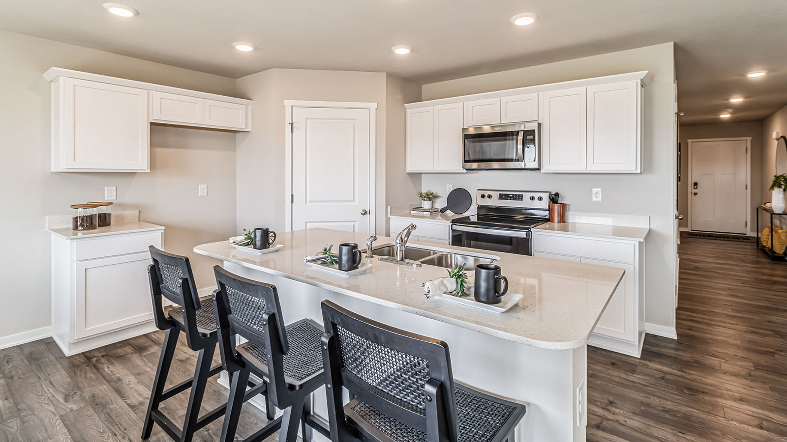 Modern kitchen with white cabinetry and stainless-steel appliances