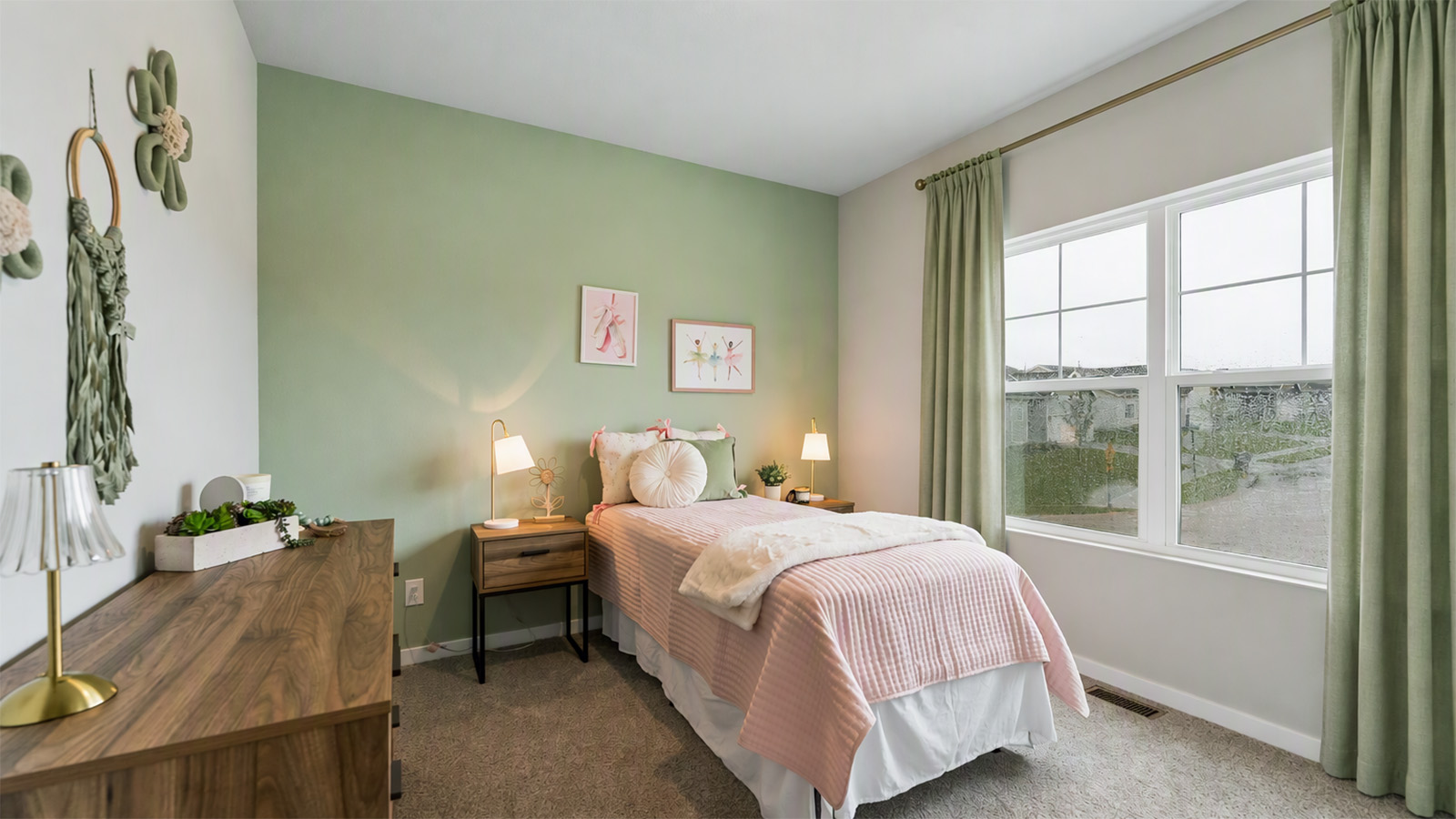 Second bedroom in the Hamilton with twin bed and sage green accent wall