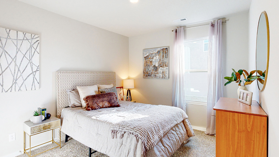 Third bedroom in the Freeport with a full bed two nightstands and a dresser