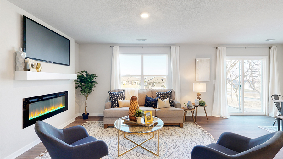 Freeport living room with natural lighting from a large window and sliding glass doors