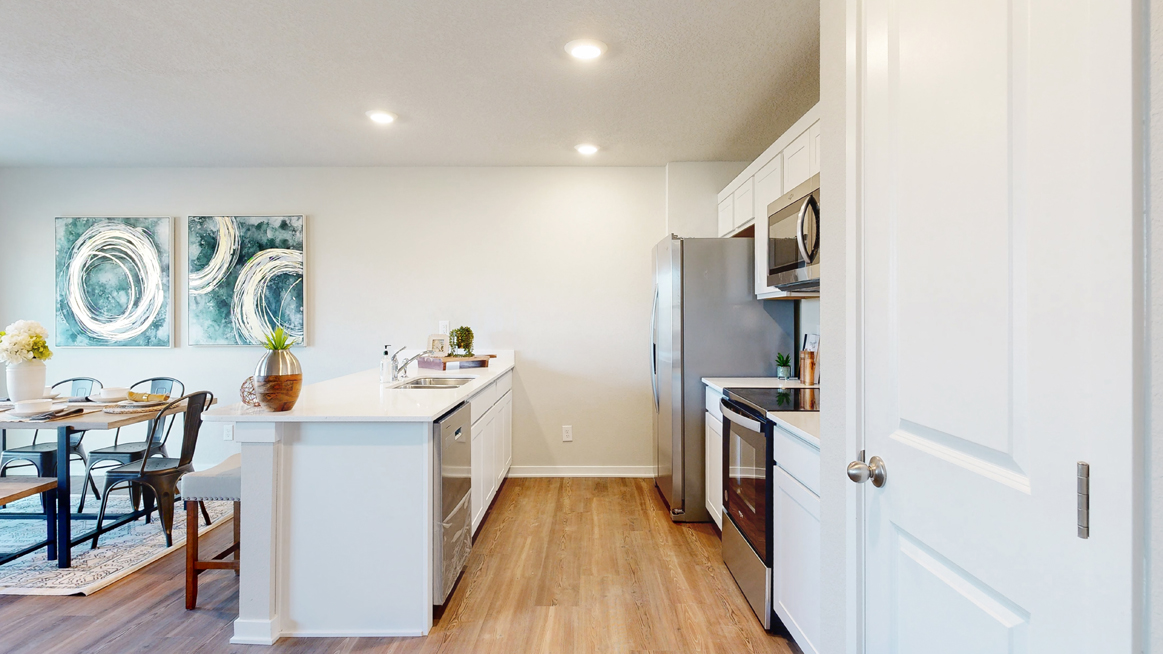 Freeport kitchen with stainless steel appliances and view into the dining room